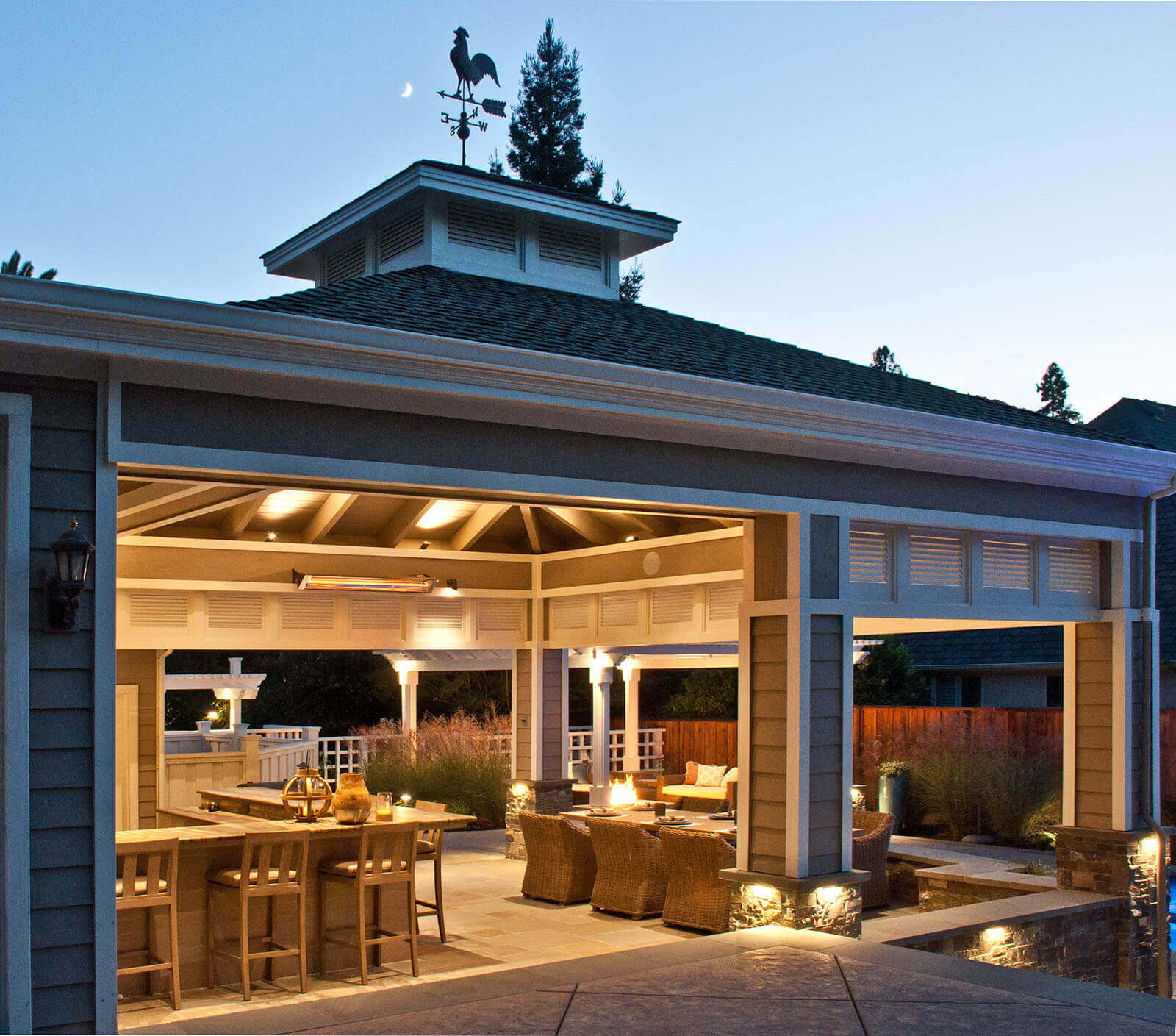 Warm ambient lighting for covered outdoor veranda, with light fixtures at base of columns