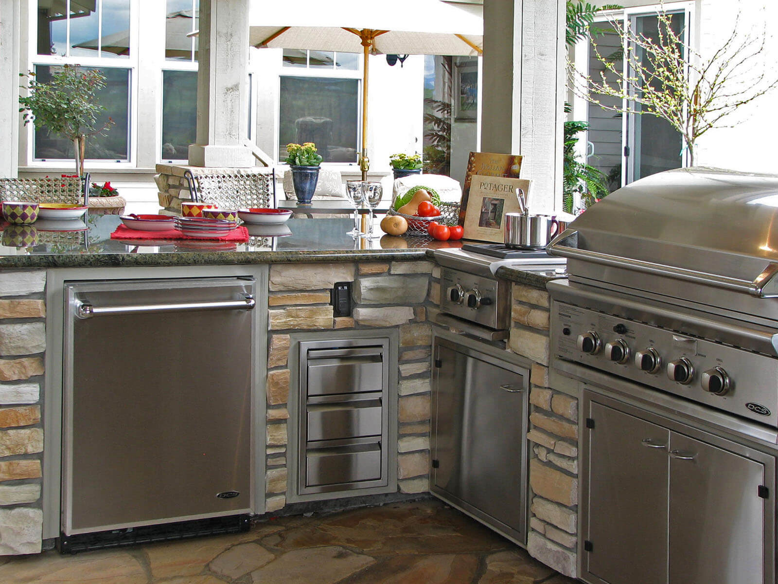 Compact patio cooking area with two burner stove and custom in-counter grill