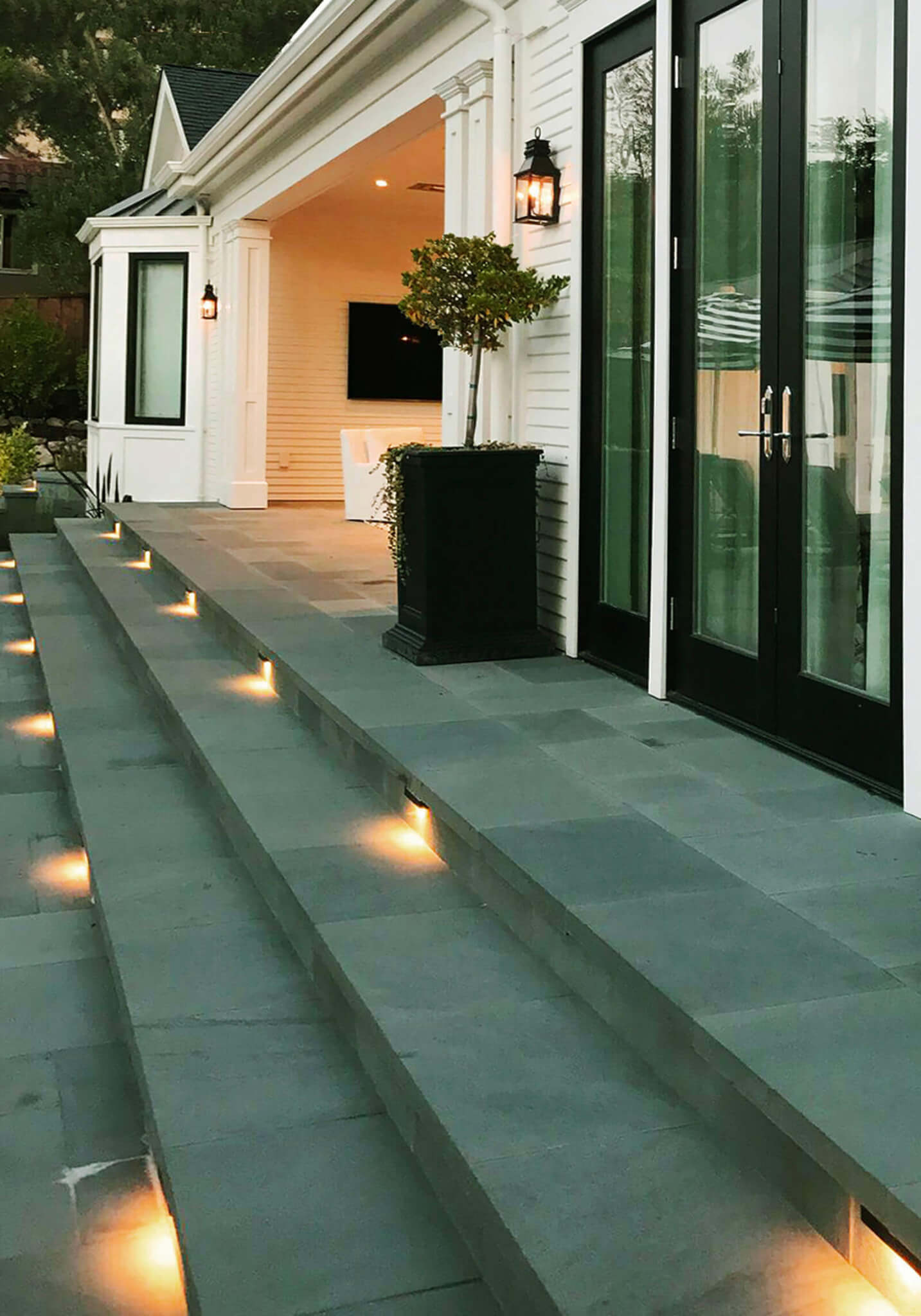 Neatly laid slate patio stairs with lighting on steps
