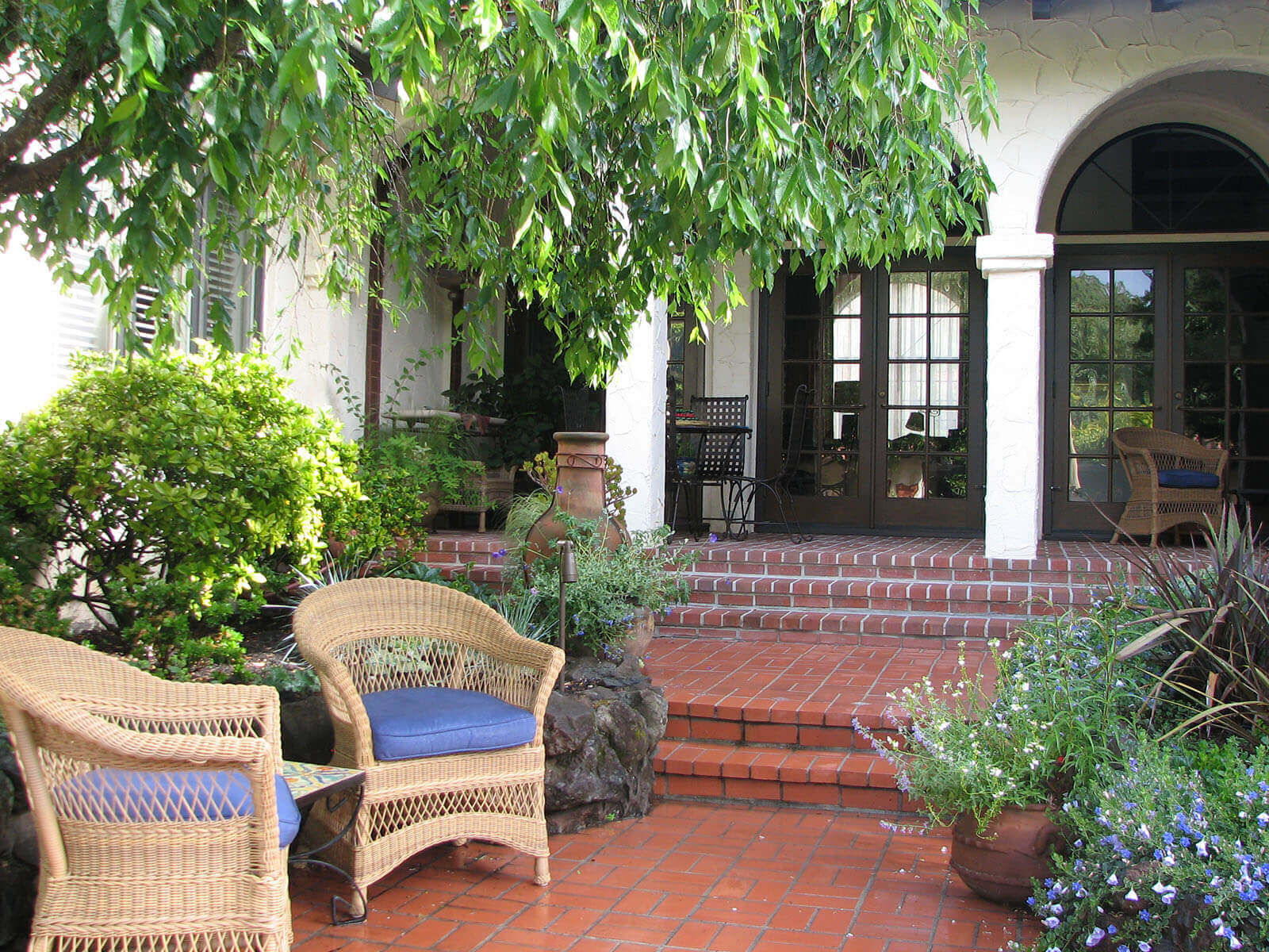 Spanish style entry courtyard with saltillo tile and elegant arches