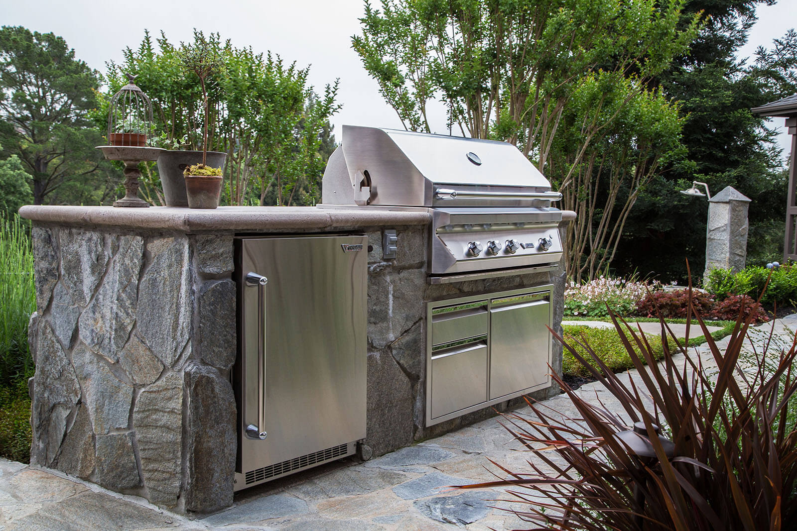 Outdoor grilling area with custom BBQ and stone counter tops with storage below