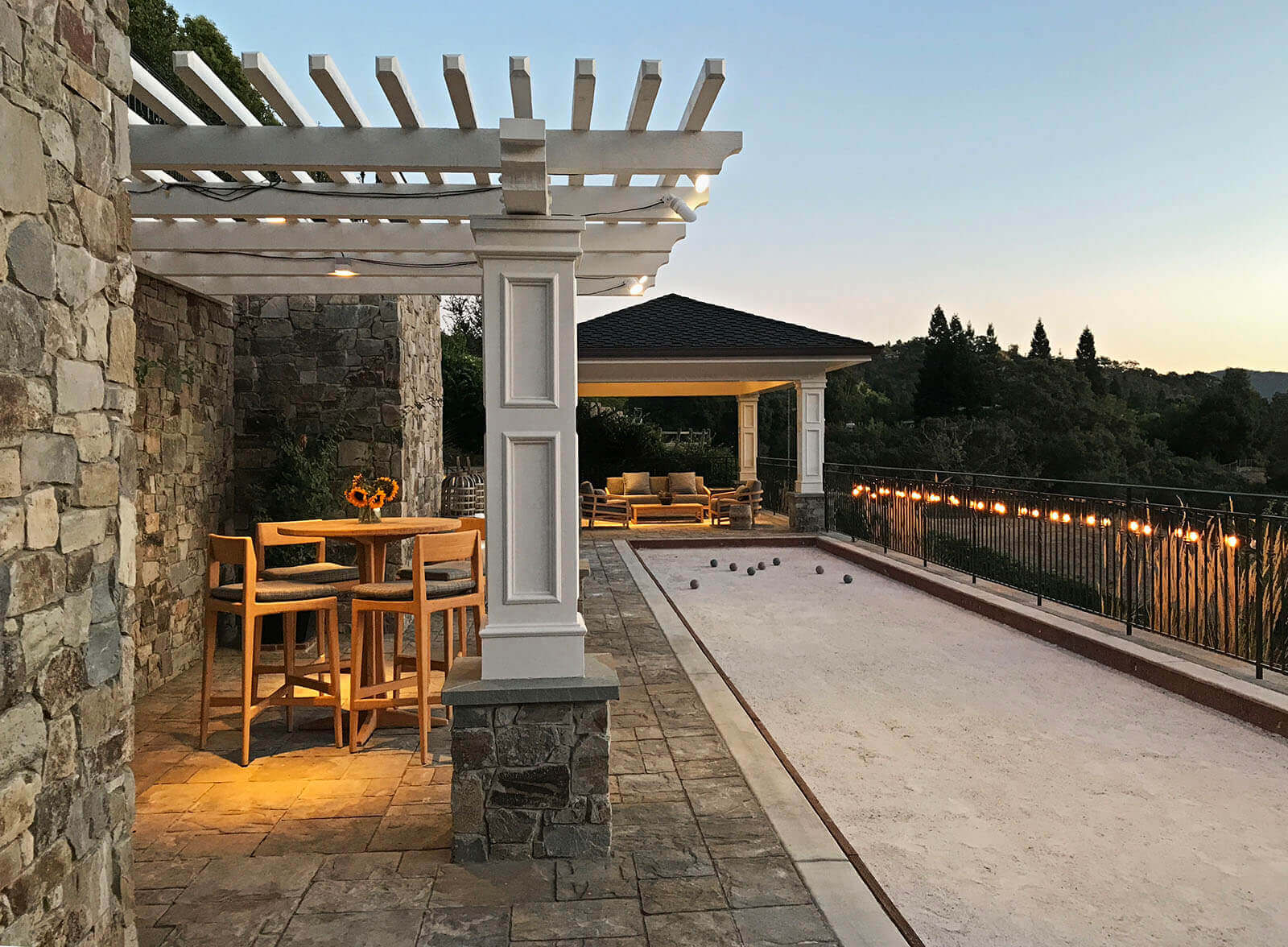 Ambient lighting in little pergola and covered veranda, with lights on the fences edge