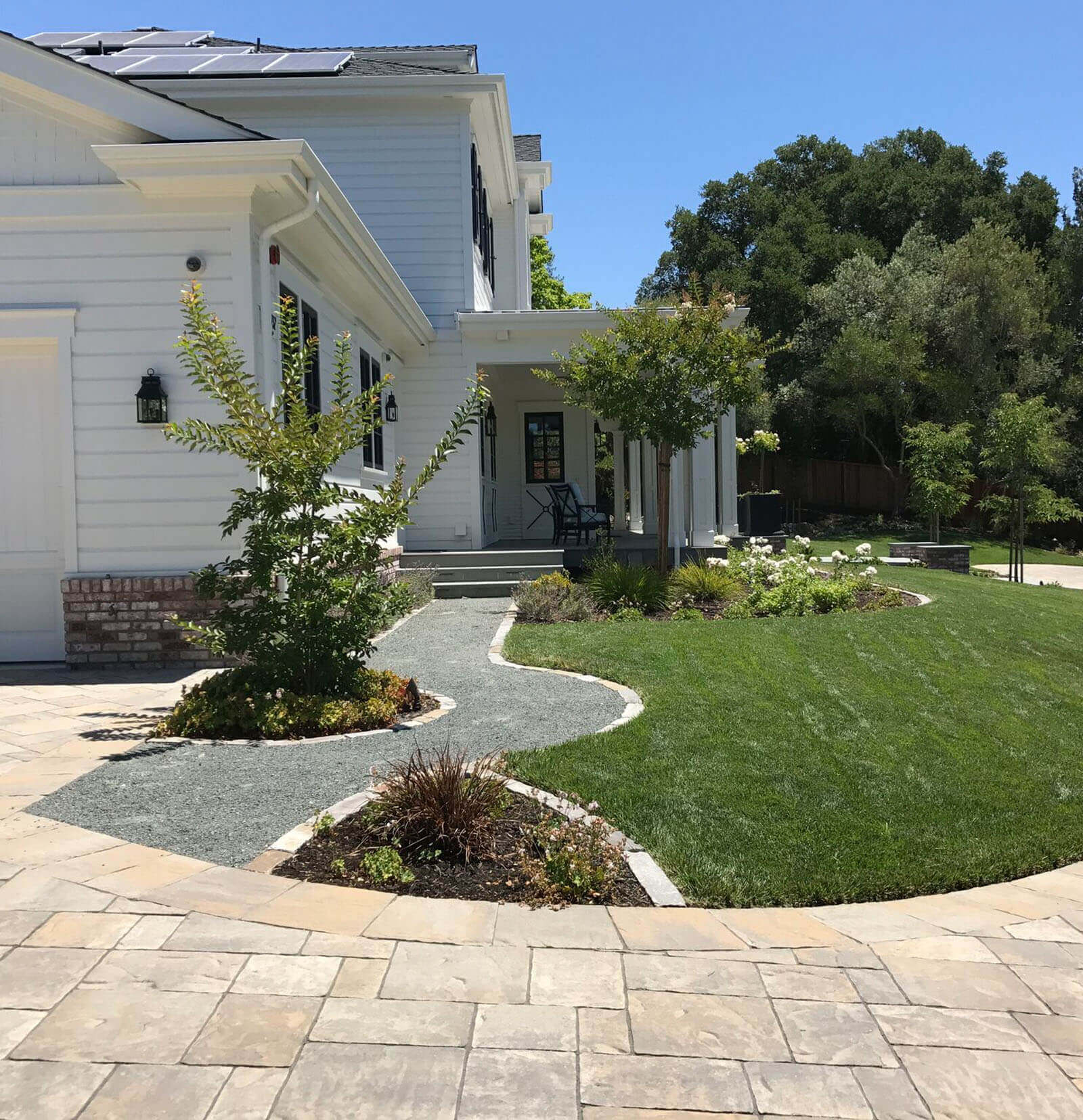 Gravel Path leading from front of house to stone tile driveway