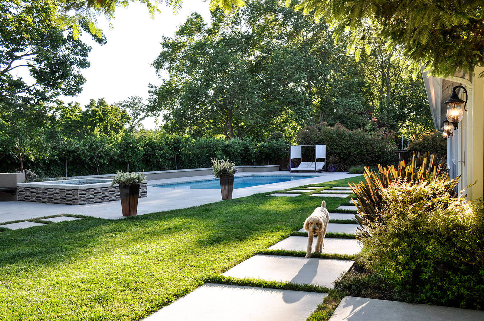 Stone tile on medium grass, with stone tile patio and pool deck