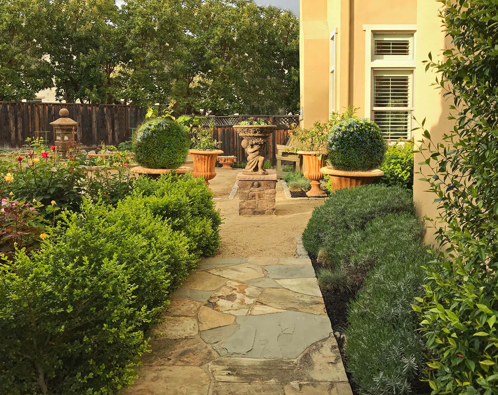 Pathway - Stone laid tile leading to gravel path and centerpiece of yard with pottery at corners