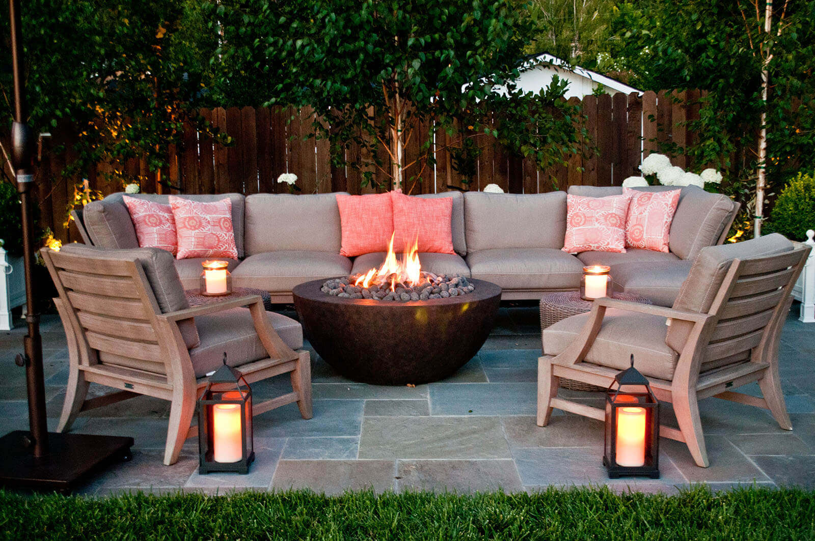 Bluestone patio with contemporary fire bowl, lanterns, and outdoor lounges