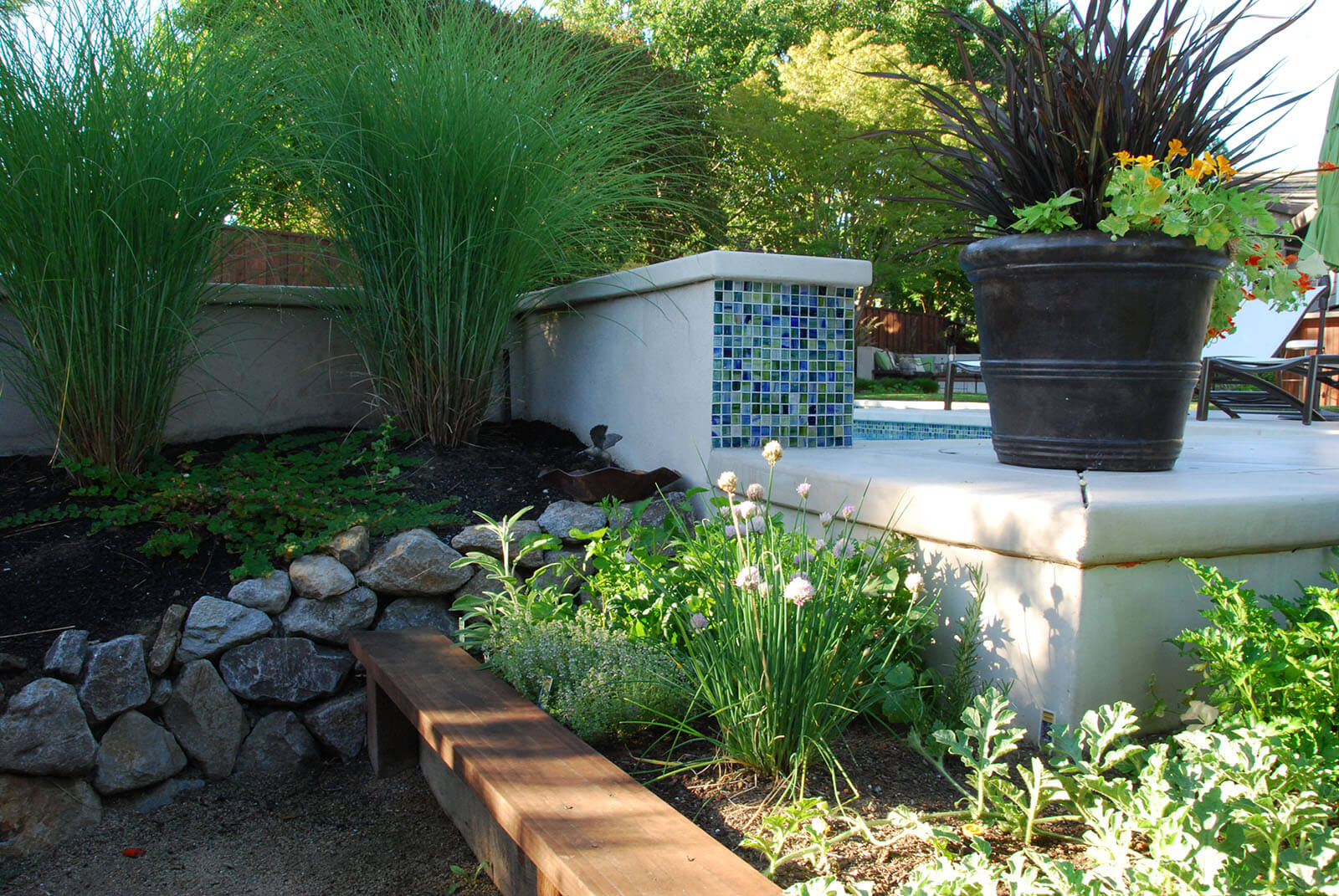 Staged planting area with wooden, stone, and potted beds
