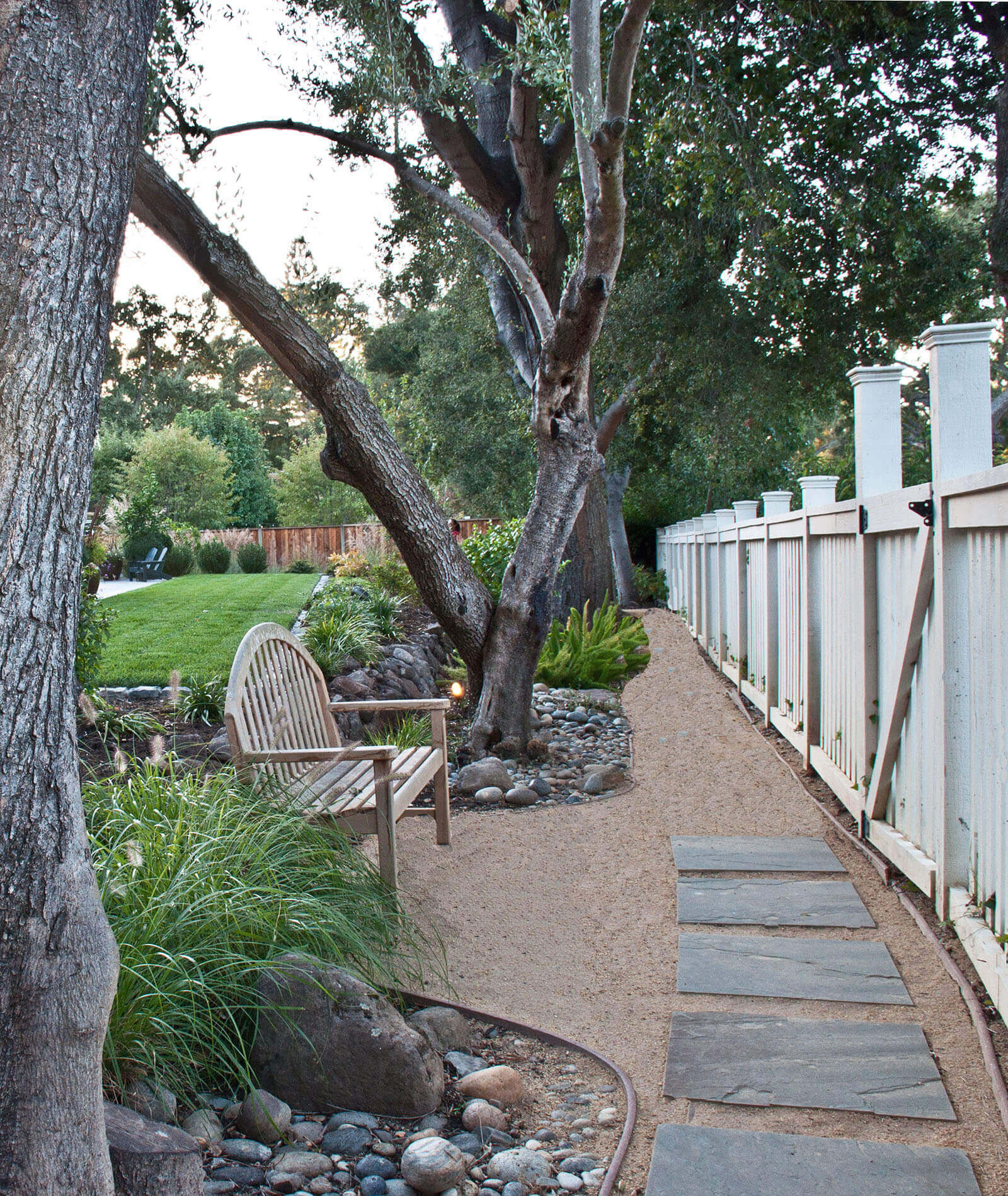 Pathway - Deitz - skinny gravel pathway with stone tiles leading around the yard, with resting bench