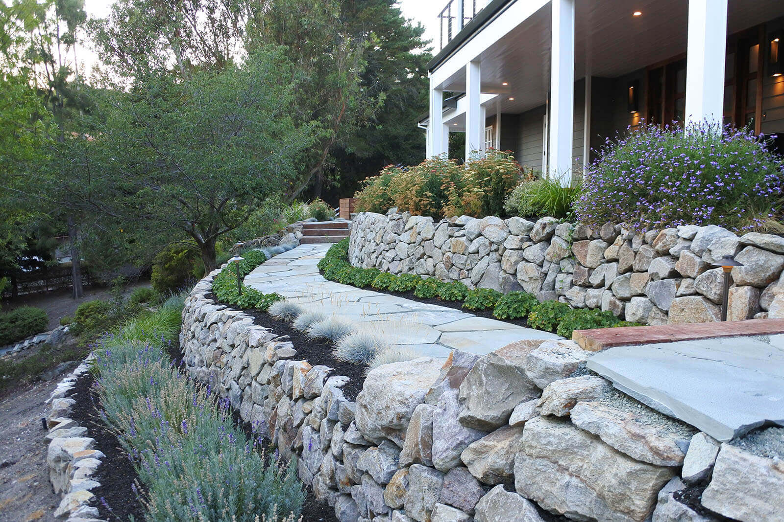 Staged garden platforms with rock walls, and stone laid pathway