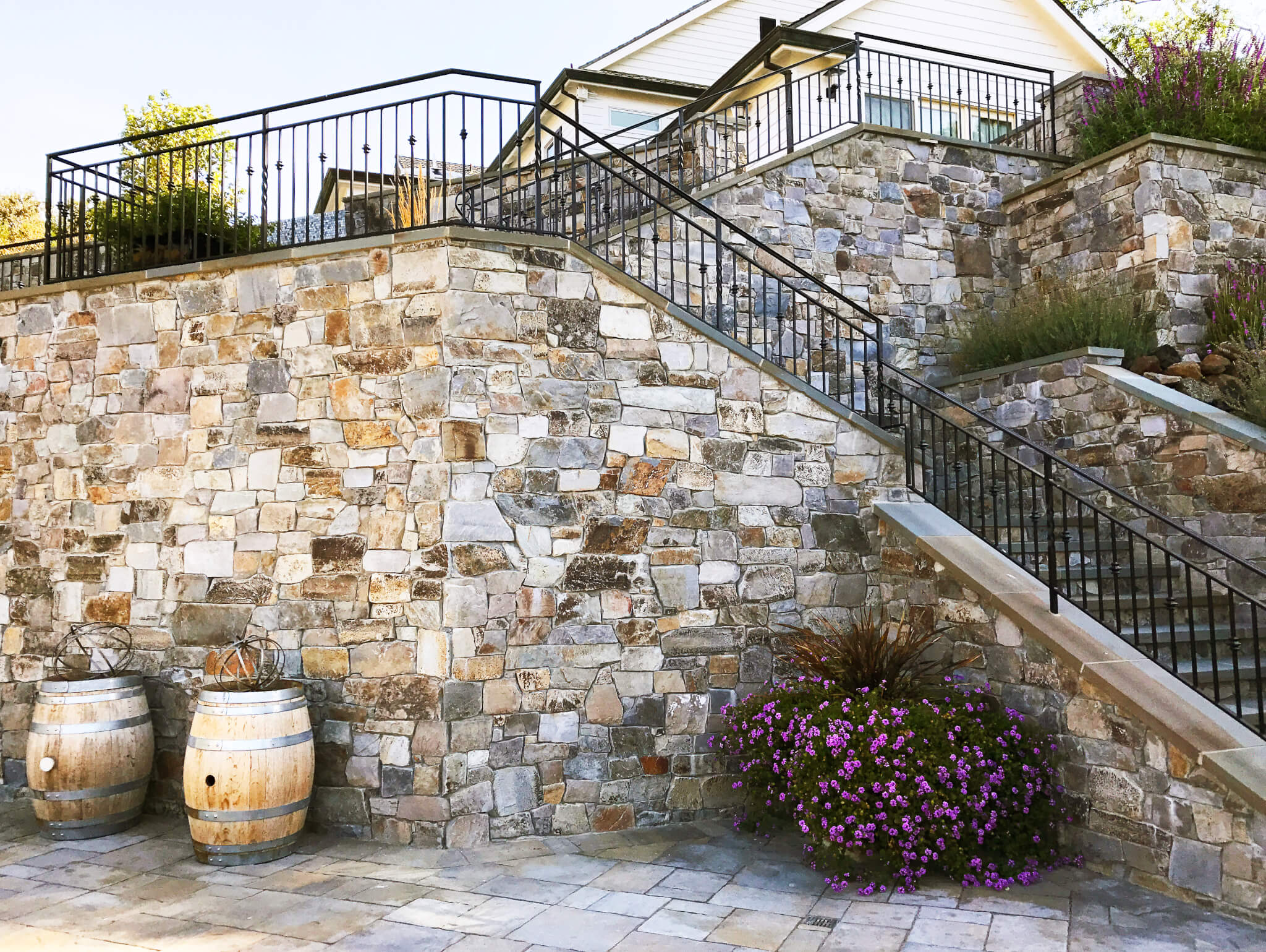 Wrought iron stair railing on stone walled staircase wrapping up two levels