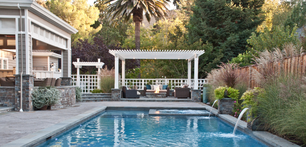ornamental pergola shade structure and gate create poolside elegance