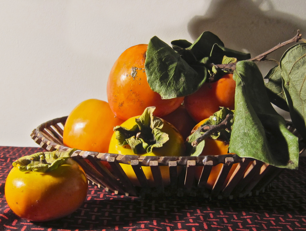 ripe persimmons in basket after a successful harvest