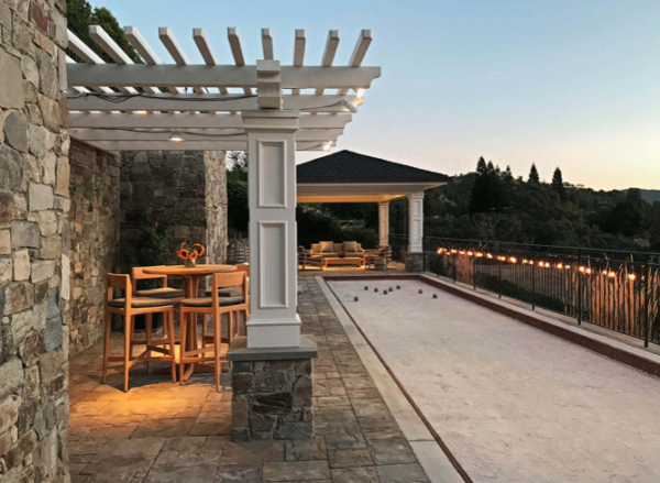 Landscape lighting on a Tuscan style pergola and bocce court