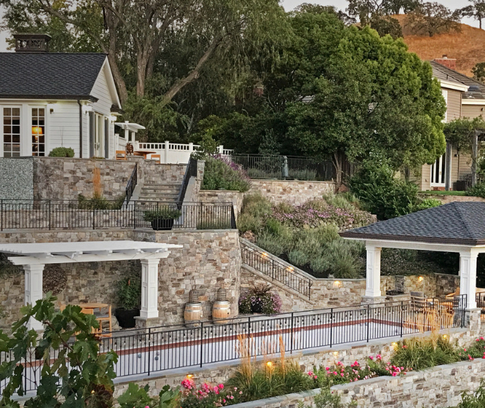 Steep terraced landscape with bocce court and structures