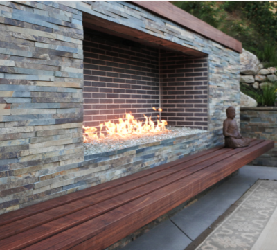 Contemporary fireplace with stone veneer and Buddha statue