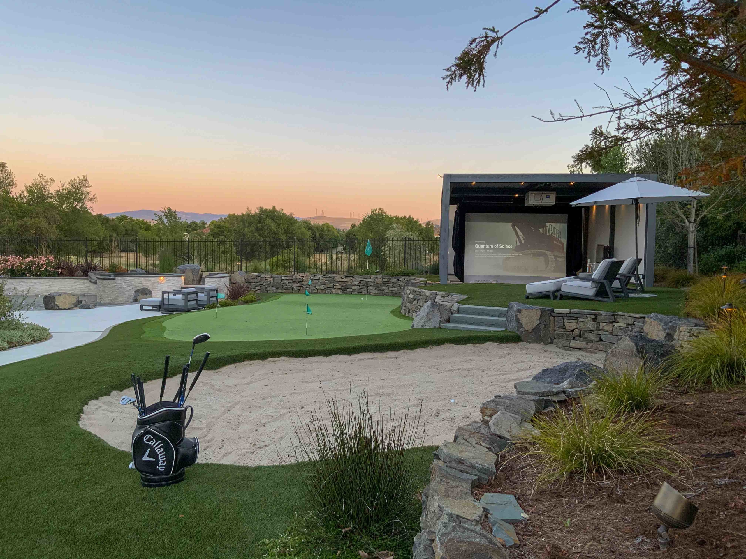 backyard golf course with outdoor movie theater