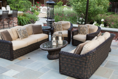 Outdoor living room with wicker furniture on bluestone patio