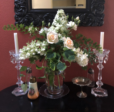 White Roses and Hydrangeas in a vase against a dark red wall