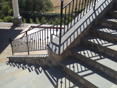 Outdoor stone stairs with wrought iron railing