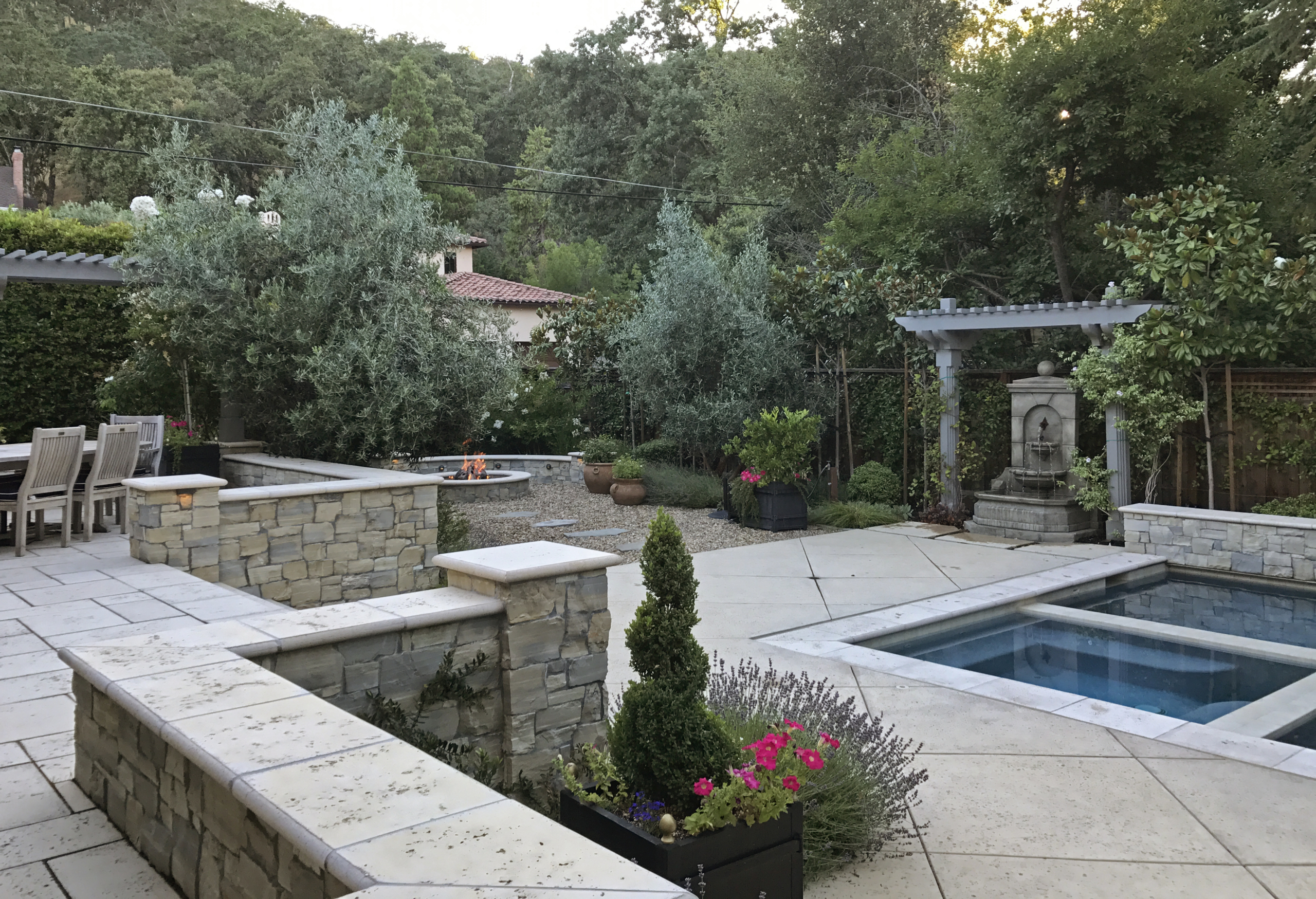 Travertine pavers and walls in a Mediterranean style landscape