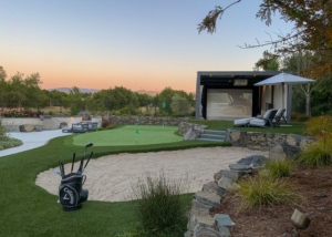 Golf course with sand pit and entertainment center overlooking lower patio
