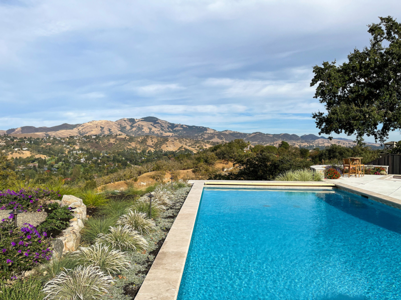 Engineered edge pool with contemporary planting overlooks valley and mountain view