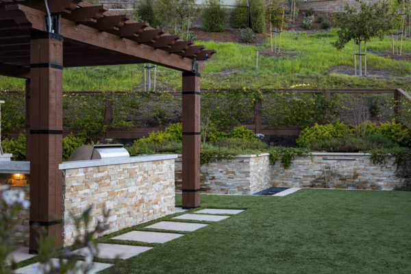 Feng Shui backyard design with fountain at base of green hillside