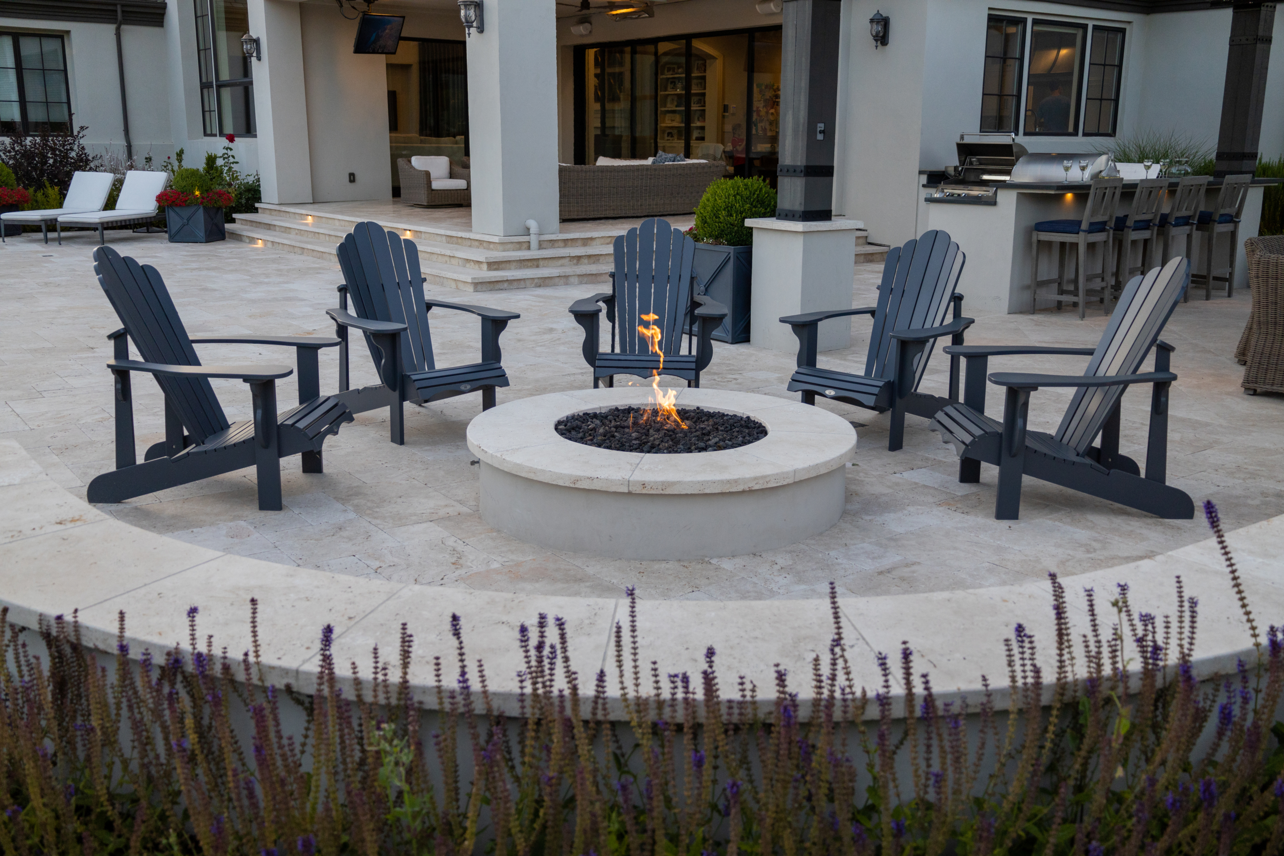 Modern round firepit with Adirondack chairs